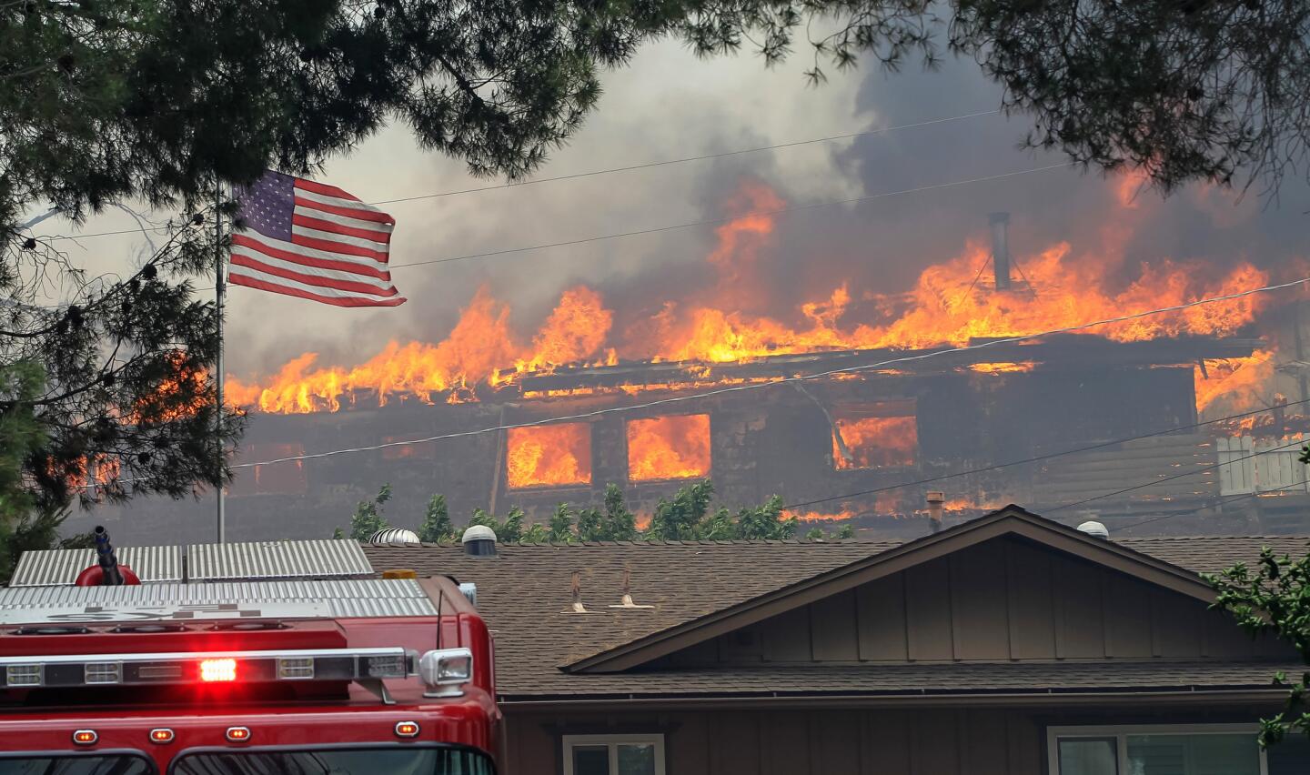 A home burns near Olive View Road on Friday during a fire in Alpine, California.