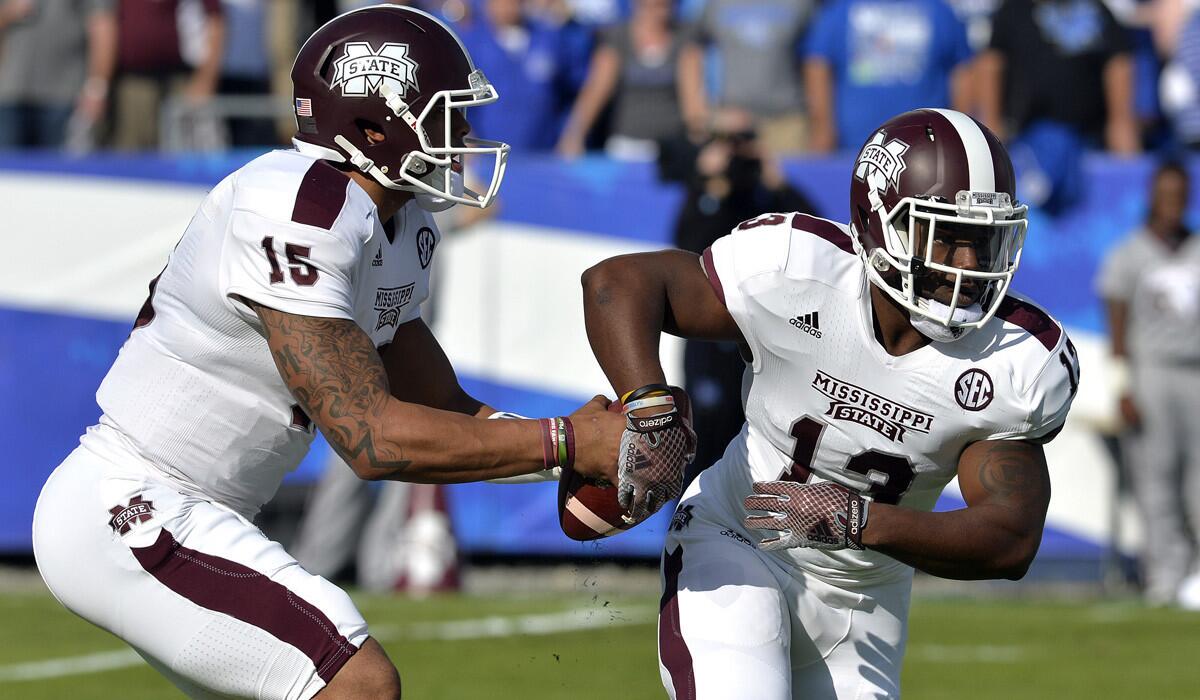 Mississippi State quarterback Dak Prescott, left, fakes a handoff to Josh Robinson during a victory over Kentucky on Saturday. The Bulldogs are not faking their No. 1 ranking.