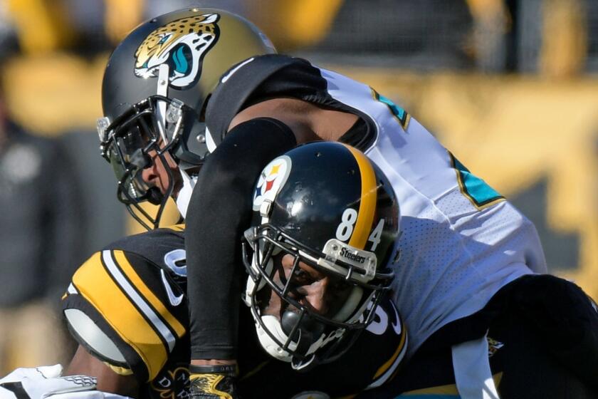 Pittsburgh Steelers wide receiver Antonio Brown (84) is tackled after making a catch by Jacksonville Jaguars cornerback Jalen Ramsey (20) during the first half of an NFL divisional football AFC playoff game in Pittsburgh, Sunday, Jan. 14, 2018. (AP Photo/Don Wright)