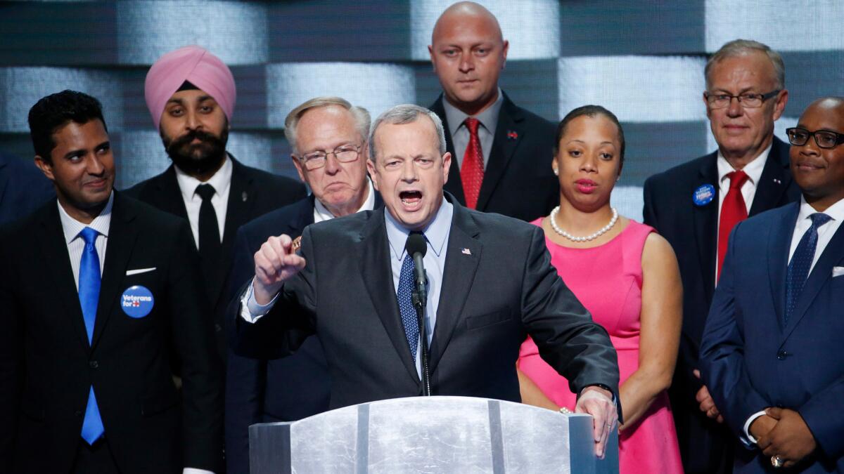 General John Allen, retired from the U.S. Marine Corps, stands on stage with a group of veterans as he speaks at the Democratic National Convention in Philadelphia on Thursday. Allen was one of many speakers who expressed worry at the prospect of a President Donald Trump.