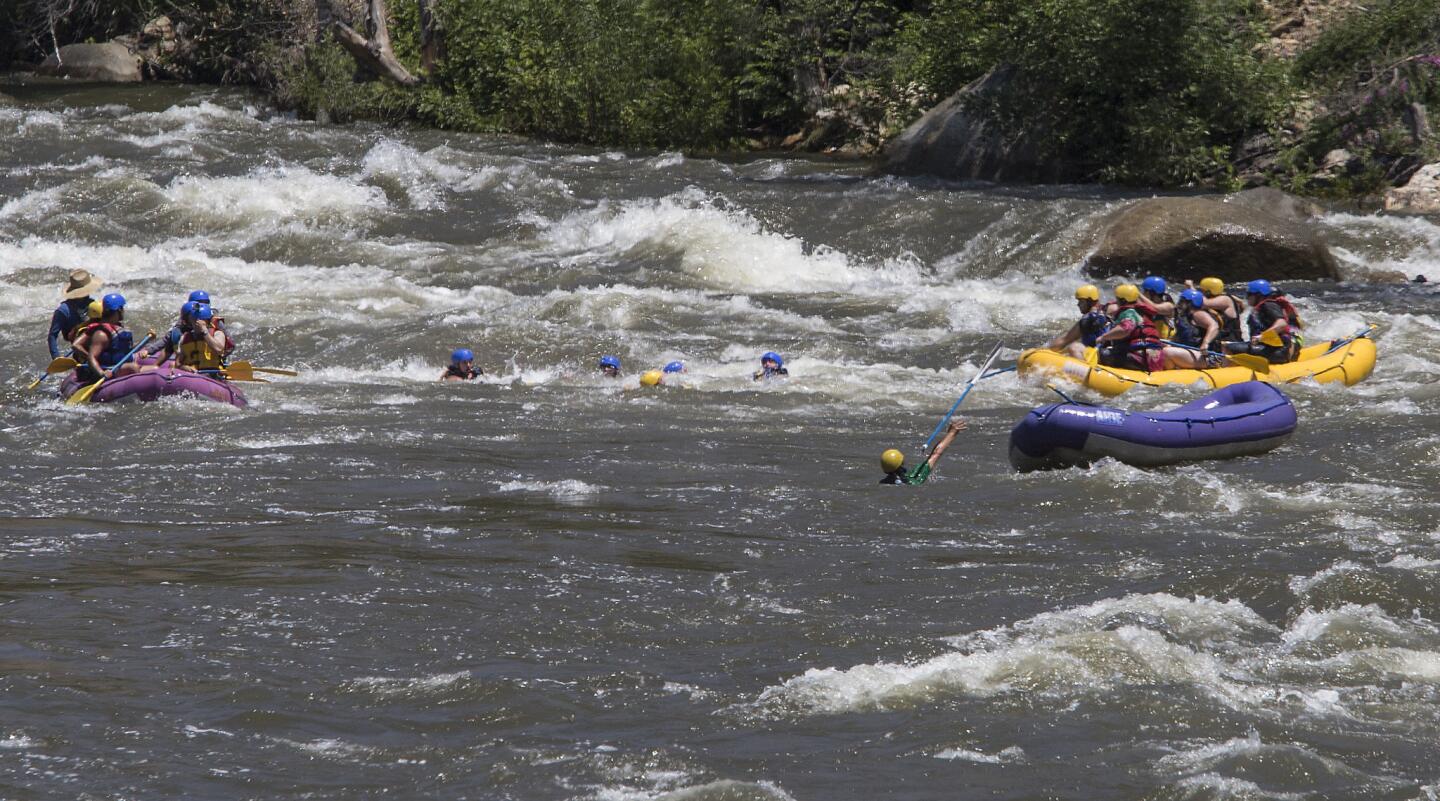Rafters are dumped into the white water of the Ewing's rapids after their raft overturned on the Kern River in Kernville, Calif.