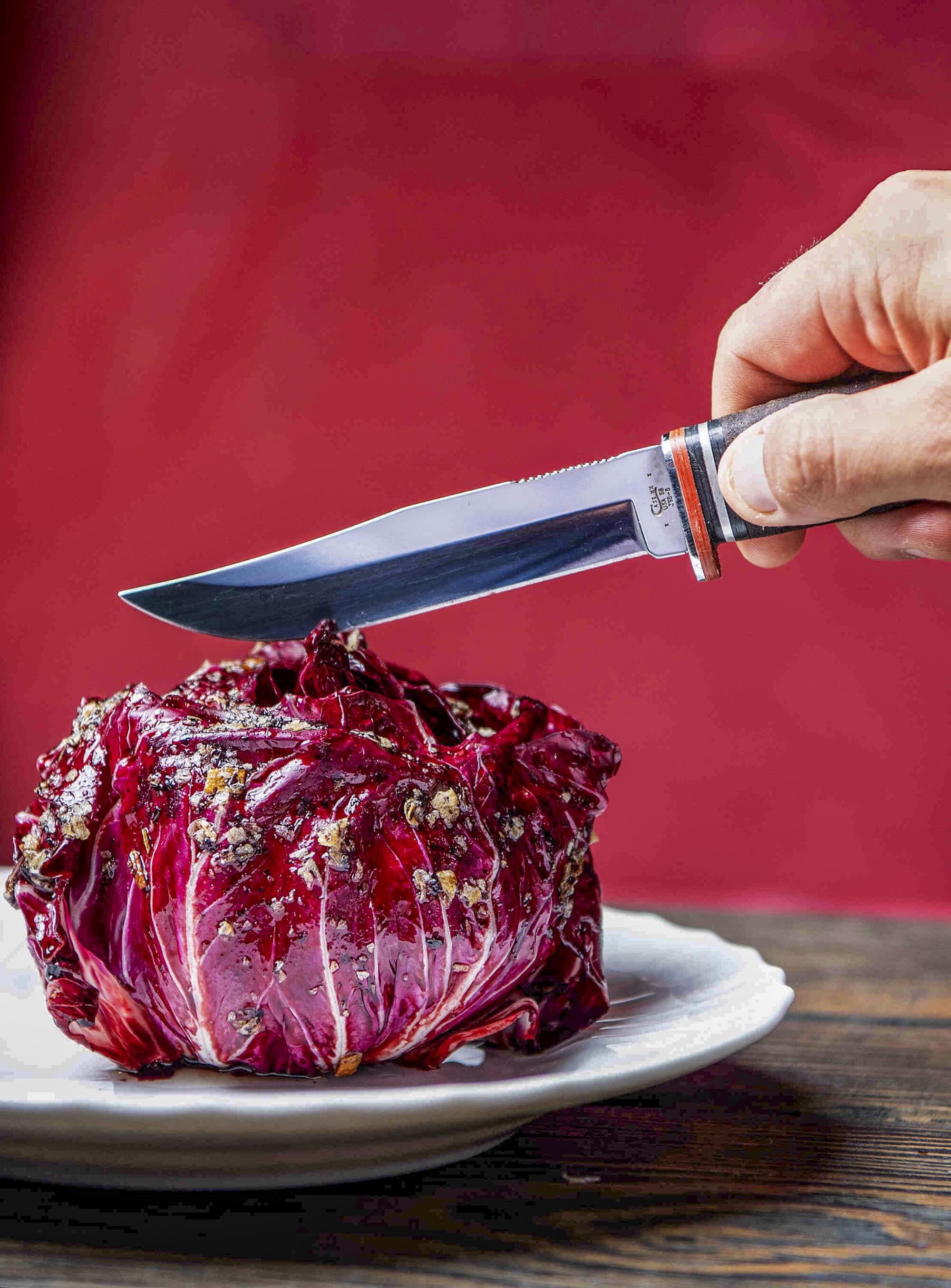 A knife is about to cut into Radicchio with Radicchio XO.