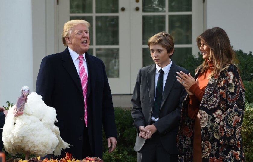 US President Donald Trump speaks after he pardoned the turkey, Drumstick, as First Lady Melania Trump (R) and their son Barron look on during the turkey pardoning ceremony at the White House in Washington, DC on November 21, 2017.