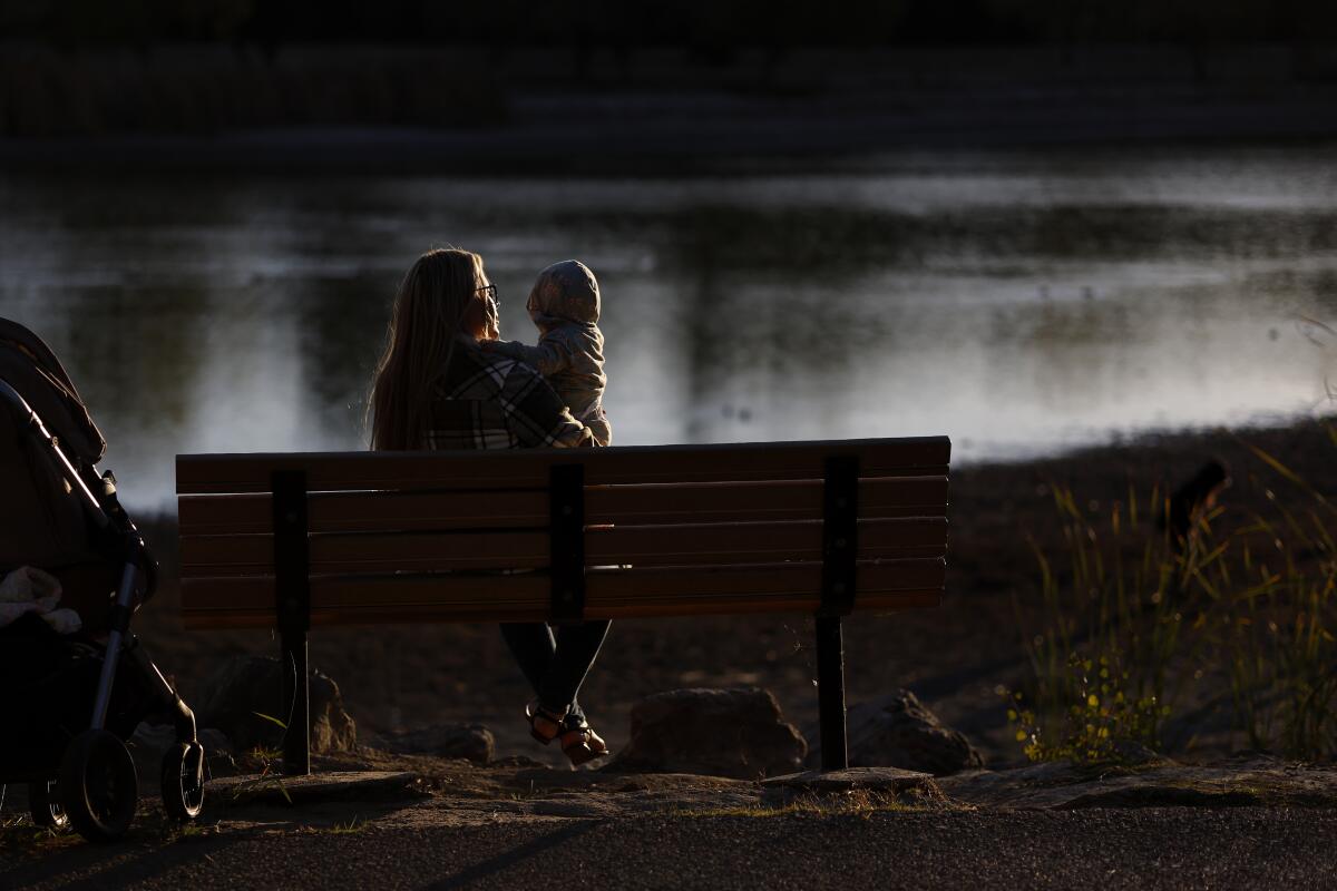 Portrait of Allison, who does not want last name to be used, with her 11 month old baby at a park in San Jose.