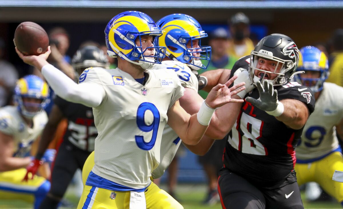 Rams quarterback Matthew Stafford shoots under pressure against the Atlanta Falcons.