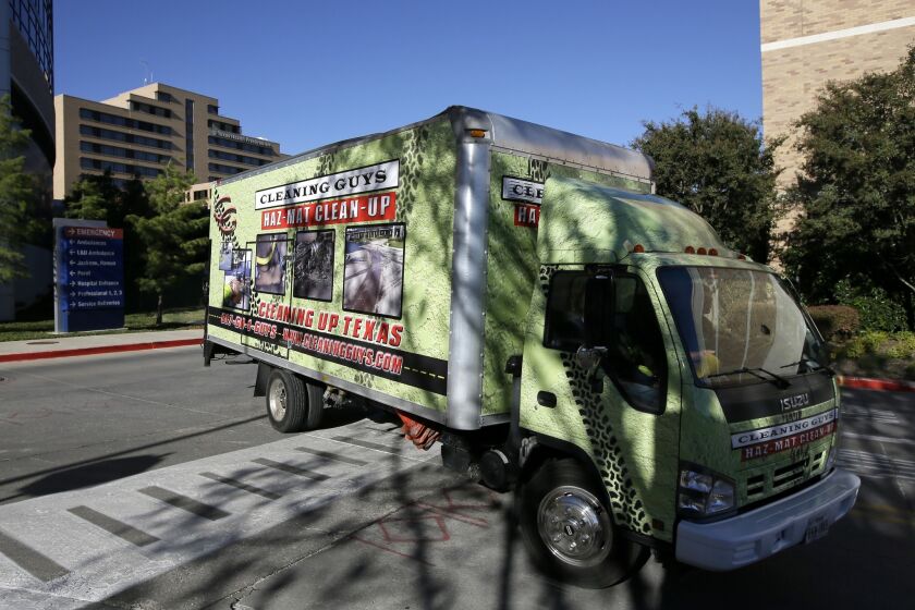 A hazardous-materials cleanup truck heads for the loading docks at Texas Health Presbyterian Hospital Dallas.