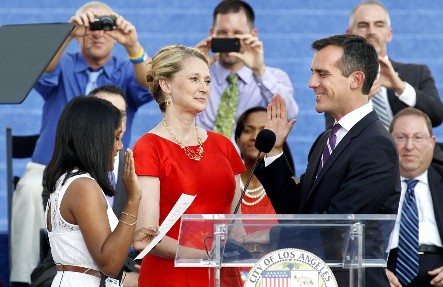 Kenia Castillo, left, an eighth-grader at Luther Burbank Middle School in Highland Park, swears in Mayor Eric Garcetti as his wife, Amy Wakeland, watches.