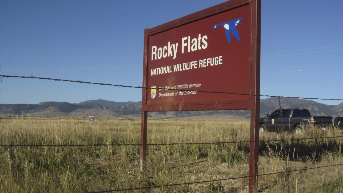 A U.S. Fish and Wildlife Service officer drives into the Rocky Flats National Wildlife Refuge outside Denver on Saturday, the first day the refuge was open to the public.