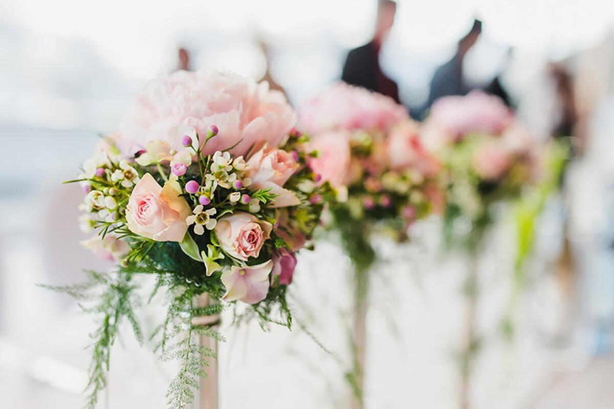 Bouquets of pink roses at a wedding