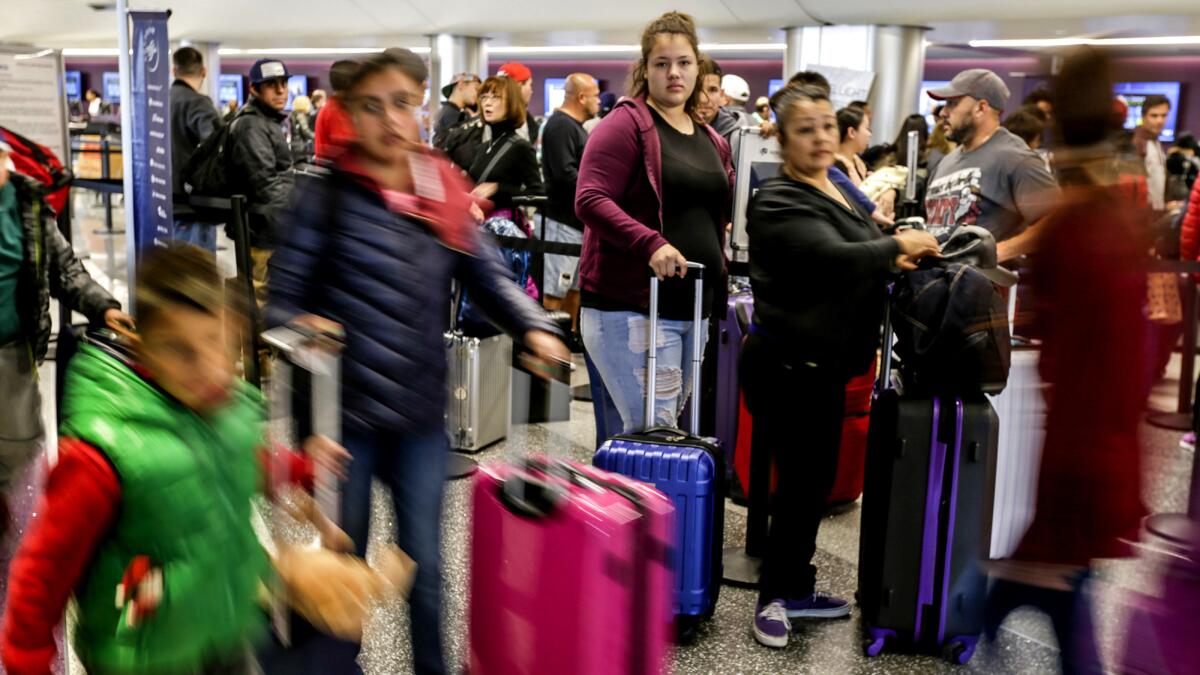 Airlines want to end several rules. Among them is a requirement for carriers to advertise full fares, including taxes and fees for items such as baggage. Above, passengers at LAX in 2016.