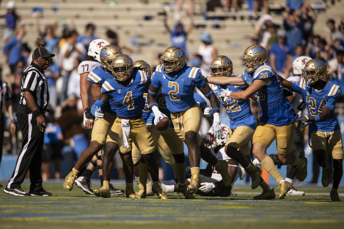 UCLA players come together on the field