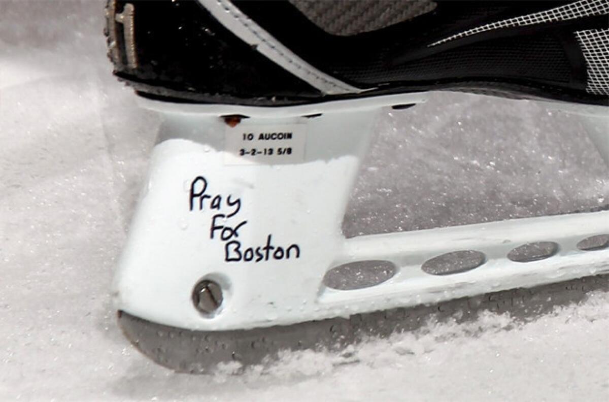 New York Islanders' Keith Aucoin skates during warmups with the words "Pray for Boston" written on his skates.