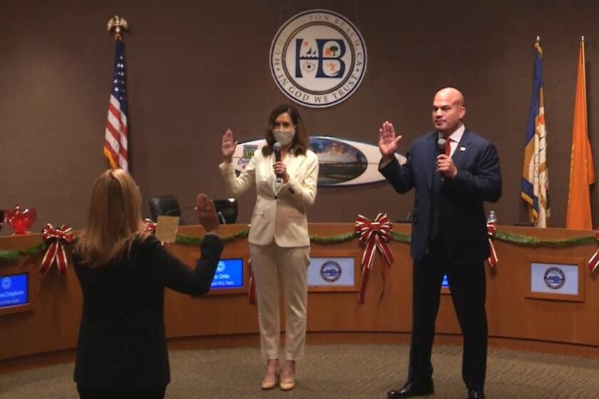 Huntington Beach City Clerk Robin Estanislau swore in new mayor Kim Carr and mayor pro tem Tito Ortiz at Monday night's City Council meeting.