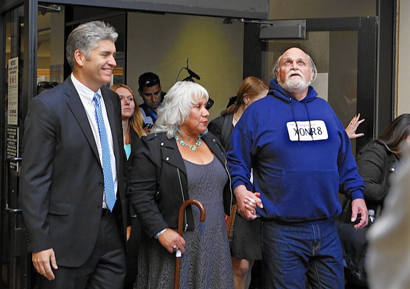 Michael Hanline, 69, looks up at the sky as he walks out of the Ventura County Jail with his wife, Sandee Hanline, and Justin Brooks, left, director of the California Innocence Project after he was released on Nov. 24, 2014.