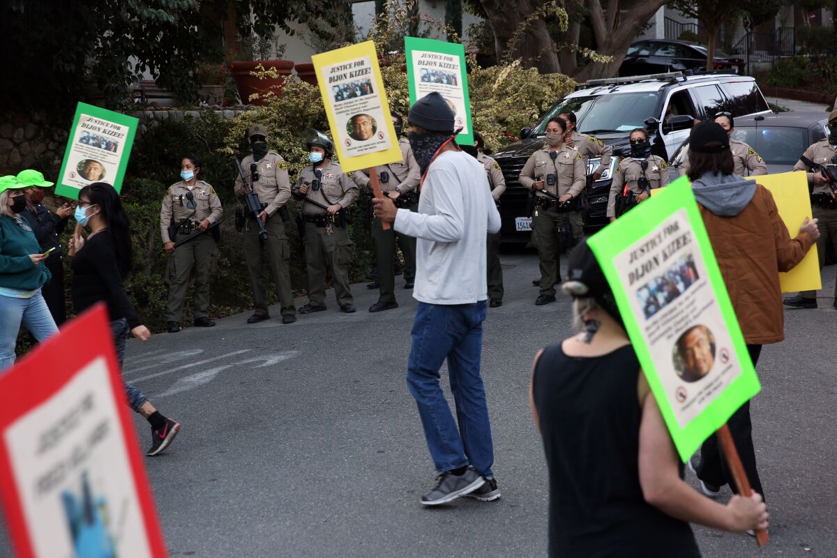Protesters with sheriff's deputies in the background