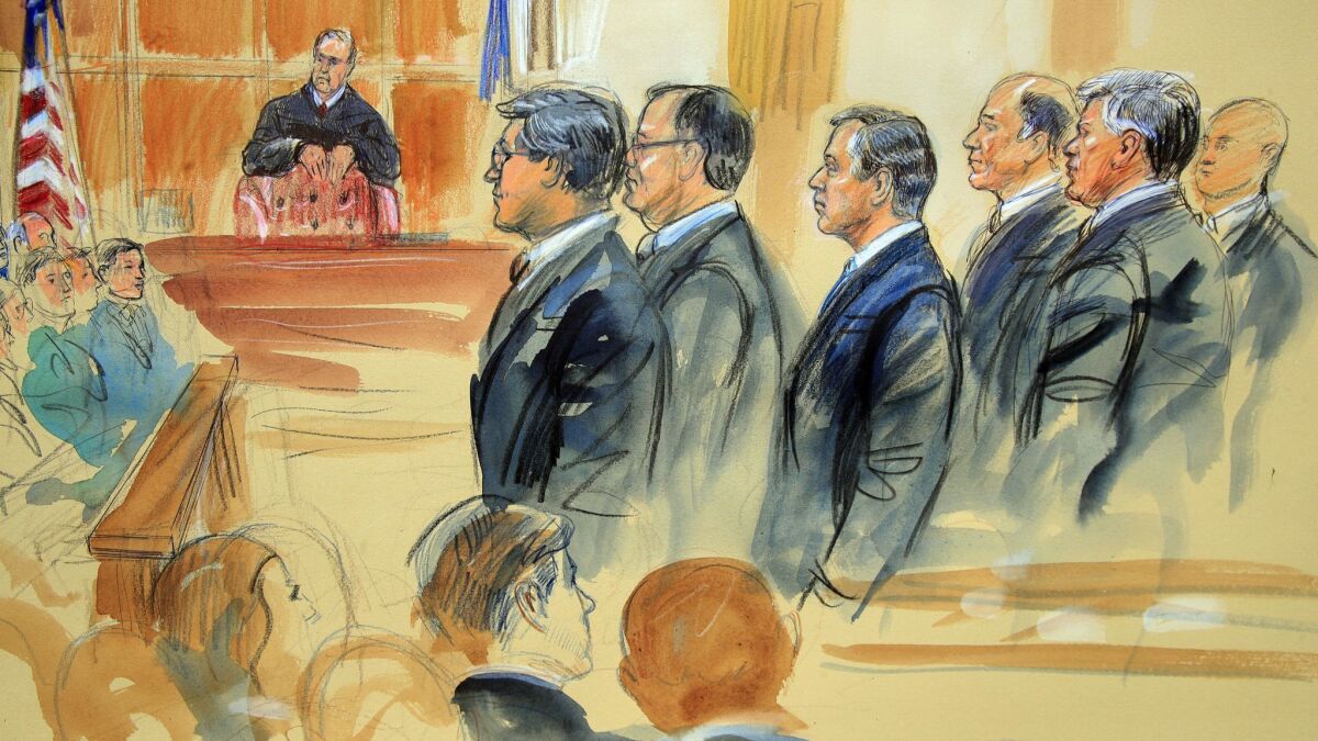 A courtroom sketch depicts Paul Manafort, fourth from right, standing with his lawyers in front of U.S. District Judge T.S. Ellis III, center rear, and the selected jury, seated left, on the first day of his trial in Alexandria, Va.