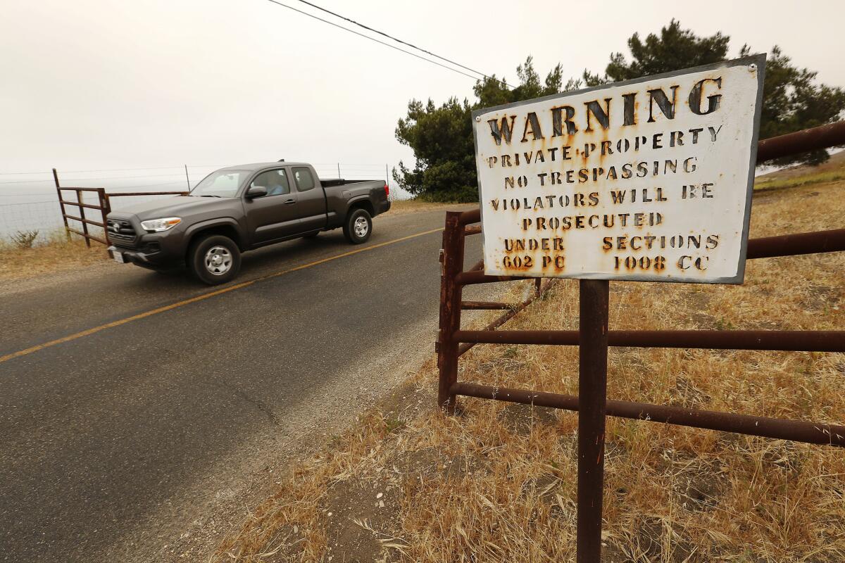Signs on narrow, curving Hollister Ranch Road warn trespassers that they are on private property.