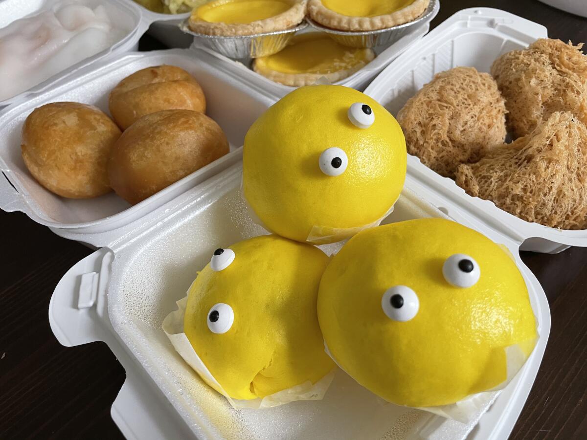 Dim Sum Co.'s signature poke bun with salted duck egg custard on the inside and cartoon googly eyes on the outside.