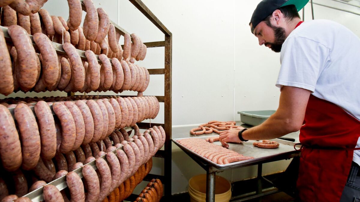 T&H Prime Meats and Sausage employee Nick Rodrigues prepares Moroccan lamb sausages at the butcher shop in San Marcos in 2015.