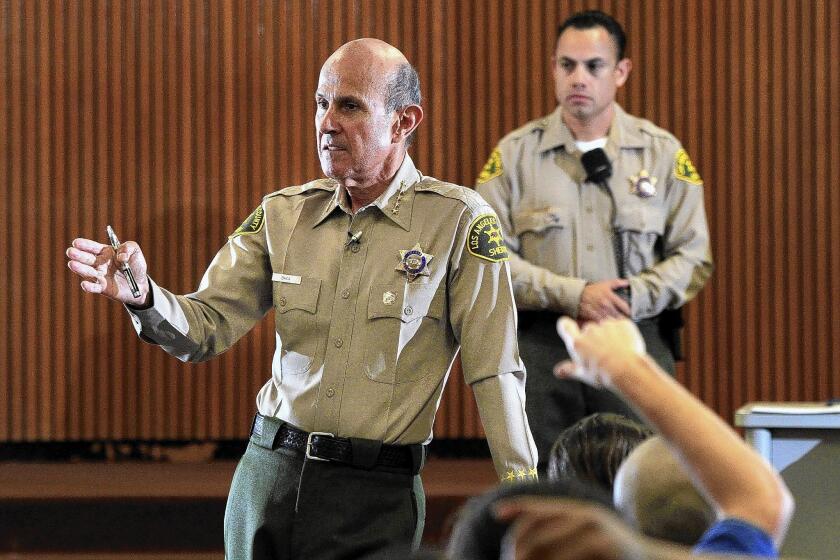 Three deputies accused of hindering a federal investigation state in court filings that former L.A. County Sheriff Lee Baca, pictured, and his then-aide, Paul Tanaka, directed the handling of a jail inmate working as an FBI informant.