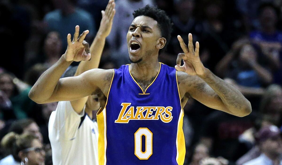 Lakers forward Nick Young celebrates after making the winning three-point shot against the Spurs with seven seconds left in overtime on Friday night in San Antonio.
