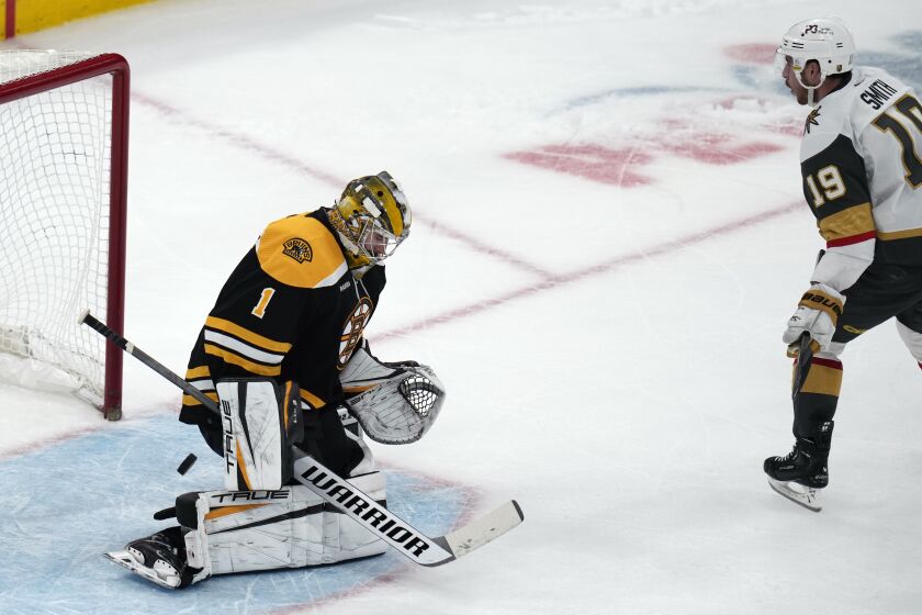 Boston Bruins goaltender Jeremy Swayman (1) drops to his pads as the puck bounces into the goal on a shot by Vegas Golden Knights right wing Reilly Smith (19) during a shoot out following an overtime period, during an NHL hockey game, Monday, Dec. 5, 2022, in Boston. Smith scored the only goal in the shoot out, helping the Knights defeat the Bruins 4-3. (AP Photo/Charles Krupa)