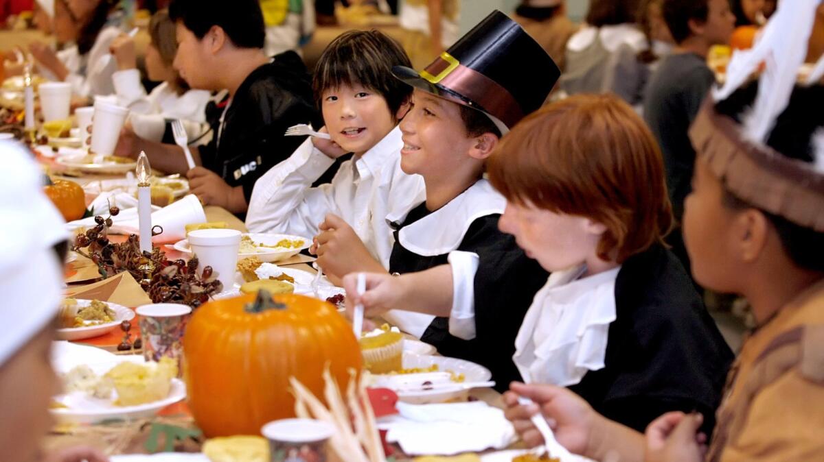 Boys and girls in costume enjoy their lunch during the La Cañada Elementary 5th grade Annual Thanksgiving Feast in La Cañada Flintridge in 2010.