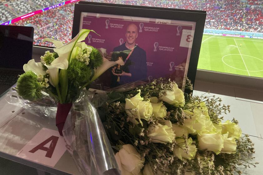 A tribute to journalist Grant Wahl is seen on his previously assigned seat at the World Cup quarterfinal soccer match between England and France, at the Al Bayt Stadium in Al Khor, Qatar, Saturday, Dec. 10, 2022. Wahl, one of the most well-known soccer writers in the United States, died early Saturday Dec. 10, 2022 while covering the World Cup match between Argentina and the Netherlands. (AP Photo/Graham Dunbar)