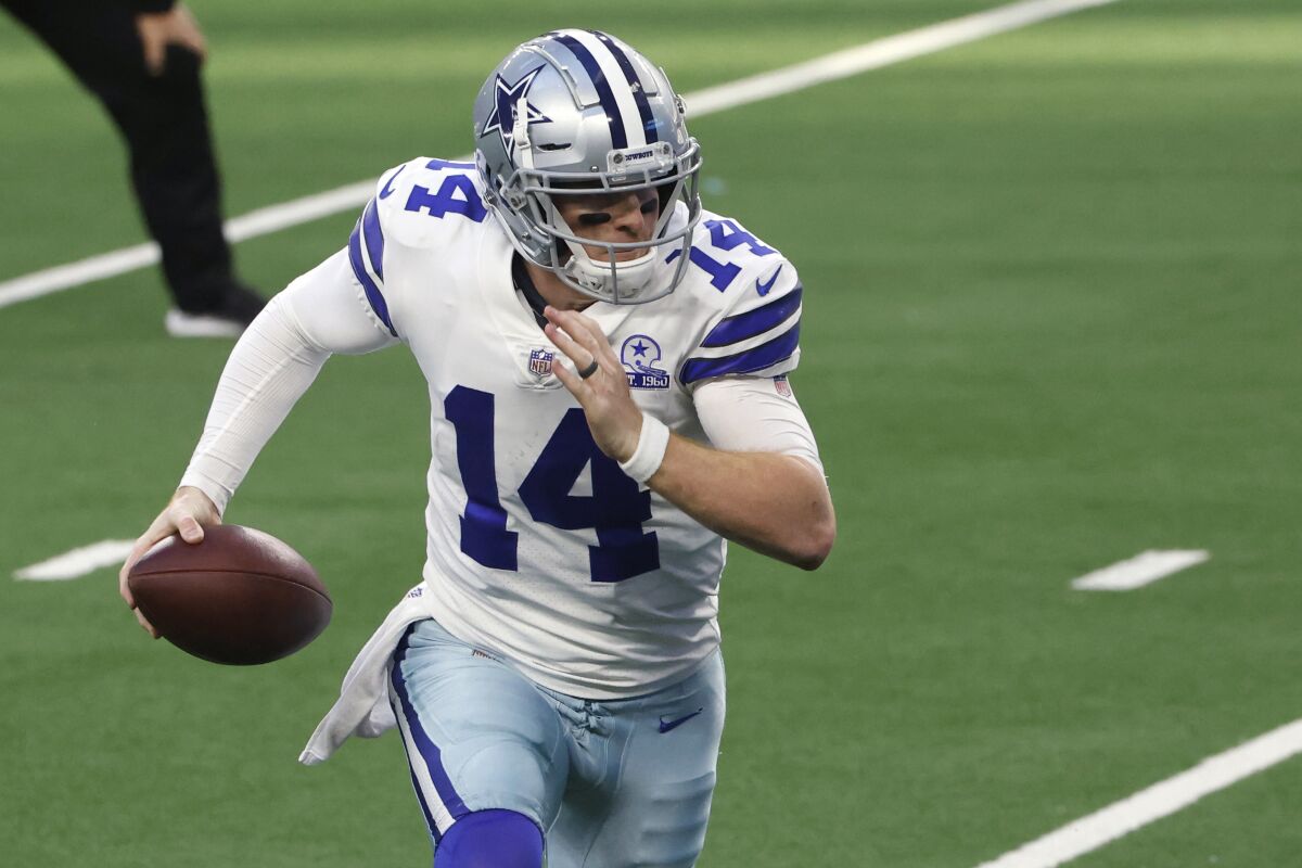 Dallas Cowboys quarterback Andy Dalton scrambles with the ball against the Philadelphia Eagles on Dec. 27.