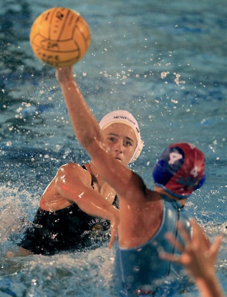 Newport Harbor High's Rachel Whitelegge, left, watches as her shot is deflected by Corona del Mar's Bobbi Hoose (4) during the first half against in the Battle of the Bay match on Friday.