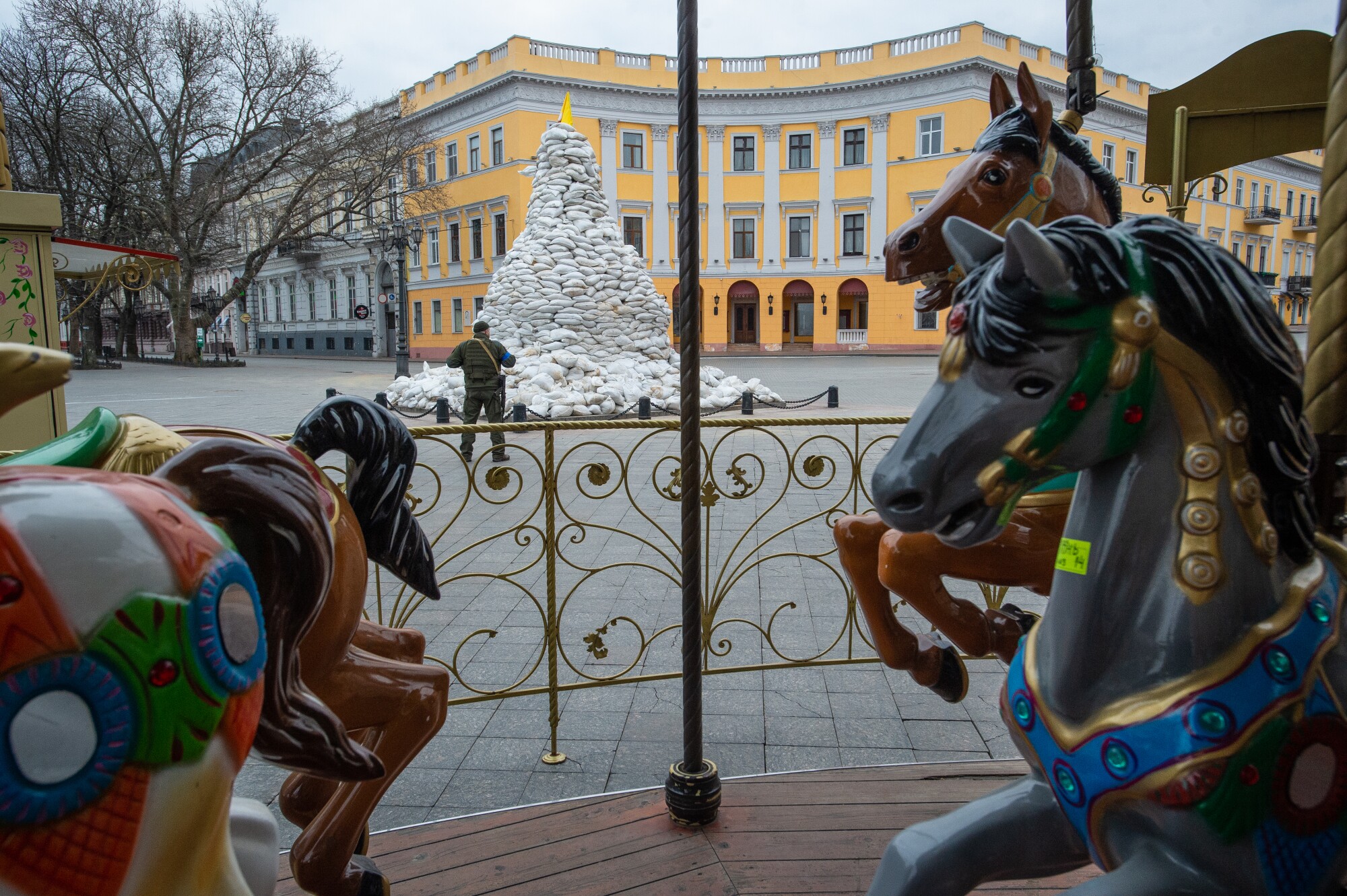 Carousel horses with sandbags in the background.