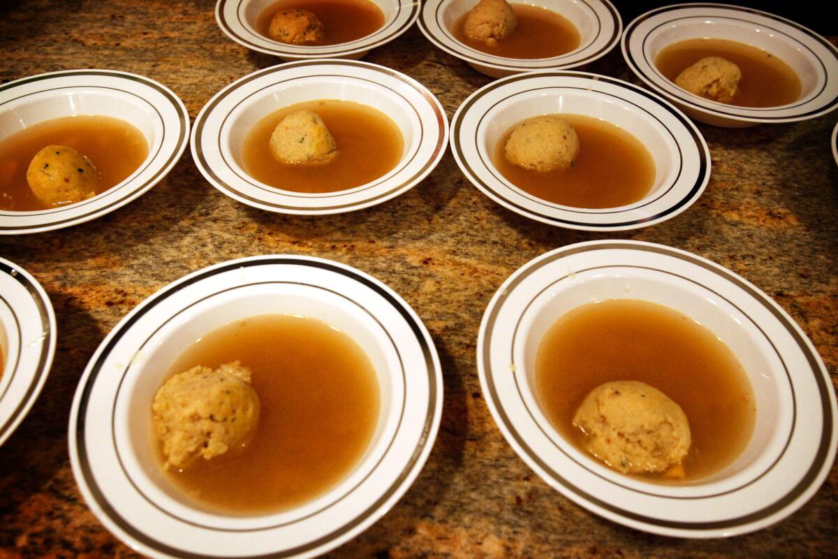 Multiple bowls of matzo ball soup at a Passover seder