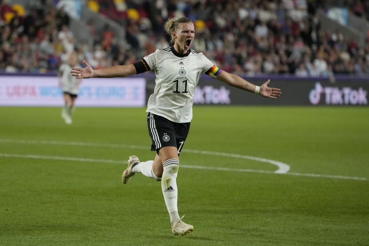 Germany's Alexandra Popp celebrates after scoring her side's second goal during the Women Euro 2022 quarter final soccer match between Germany and Austria at Brentford Community Stadium in London, Thursday, July 21, 2022. (AP Photo/Alessandra Tarantino)