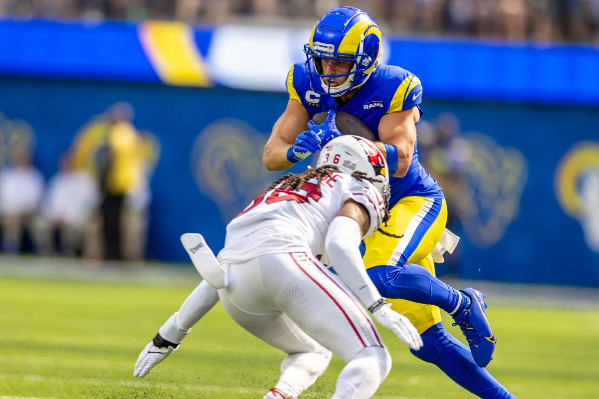 Rams wide receiver Cooper Kupp slips past Arizona Cardinals safety Andre Chachere after making a catch.