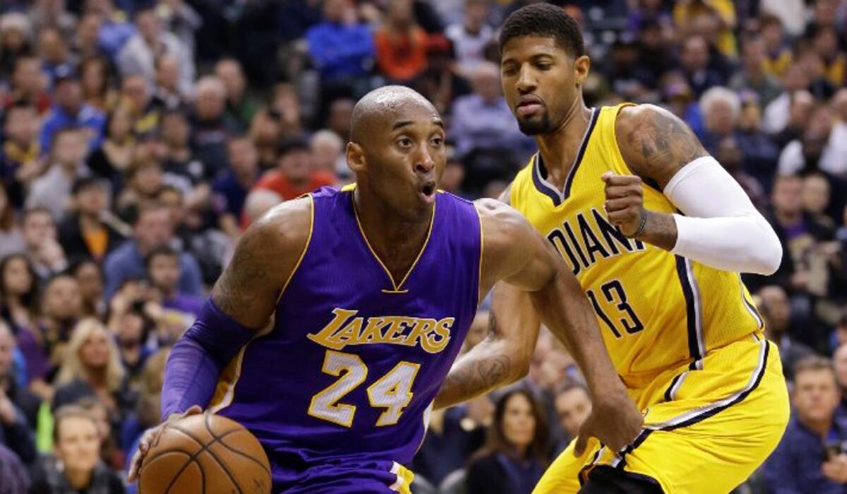 Lakers forward Kobe Bryant (24) drives past Pacers forward Paul George (13) during the first half.