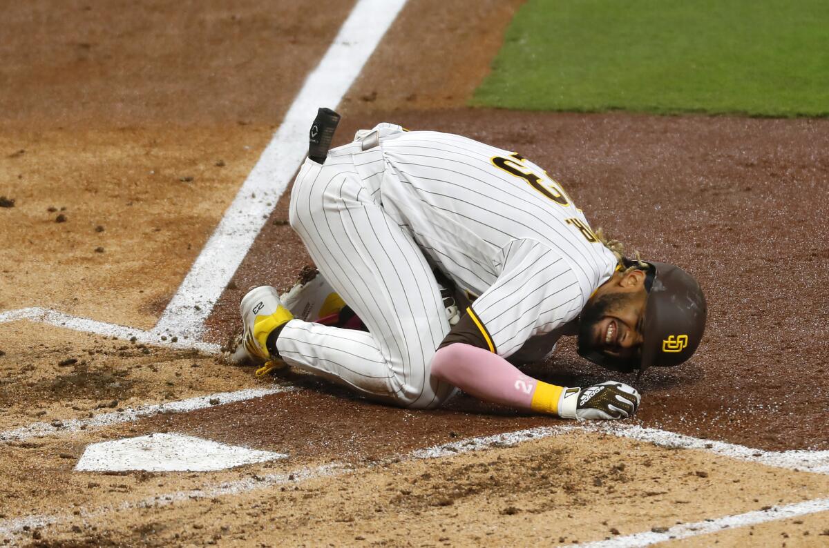 San Diego Padres' Fernando Tatis Jr. grimaces in pain.