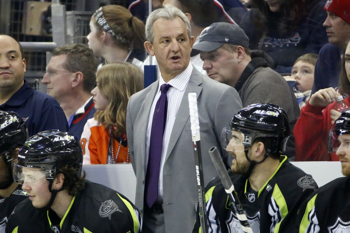 Darryl Sutter stands behind his bench during the NHL All-Star game in Columbus, Ohio, on Jan. 25.