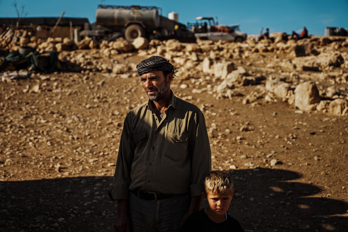 A man and his son amid a desolate landscape