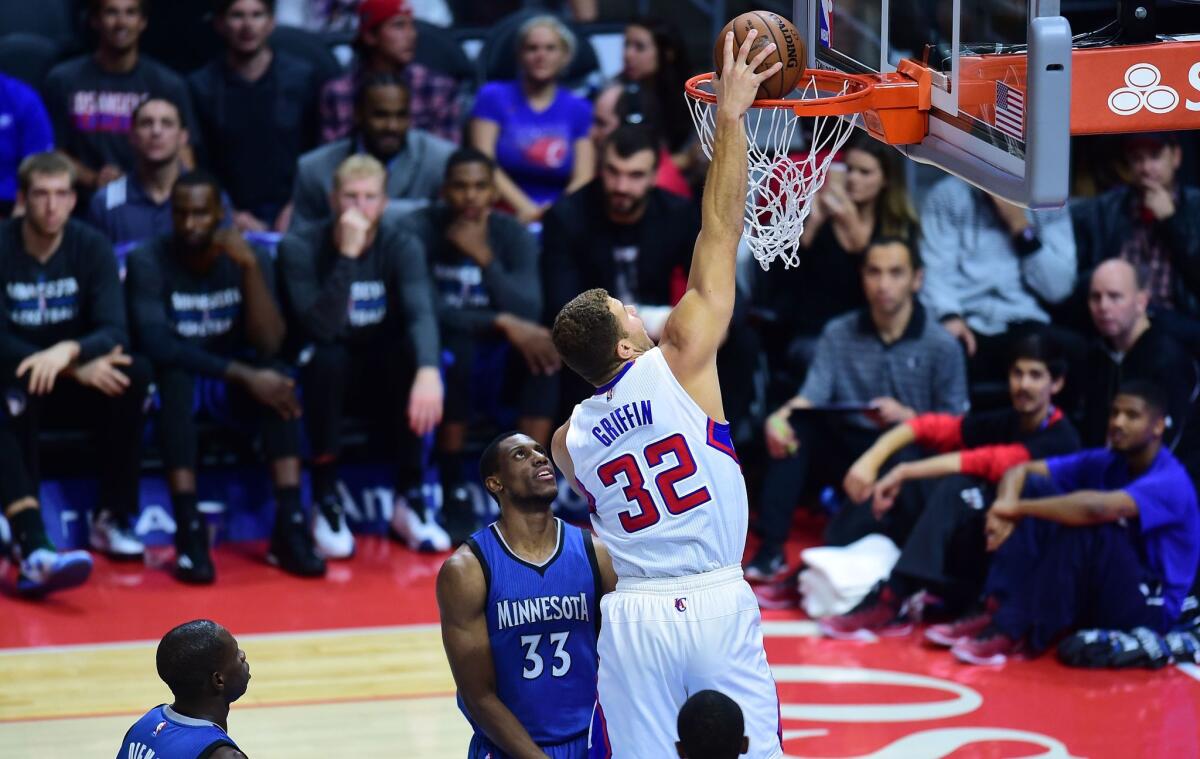 The Clippers' Blake Griffin scores as Thaddeus Young of the Minnesota Timberwolves watches during a Dec. 1 game at Staples Center.
