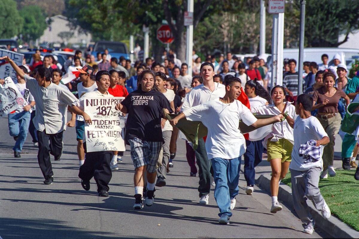 Oct. 21, 1994: About 200 students from Estancia High School in Costa Mesa march along Wake Forest Drive to protest Proposition 187.