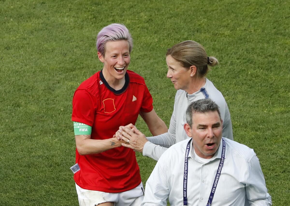 Megan Rapinoe, left, celebrates with coach Jill Ellis after a U.S. World Cup win over Spain on June 24 in Reims, France.