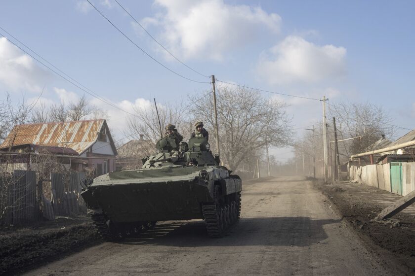 A Ukrainian APC drives towards frontline positions near Bakhmut, Ukraine, Saturday, March 4, 2023. (AP Photo/Evgeniy Maloletka)