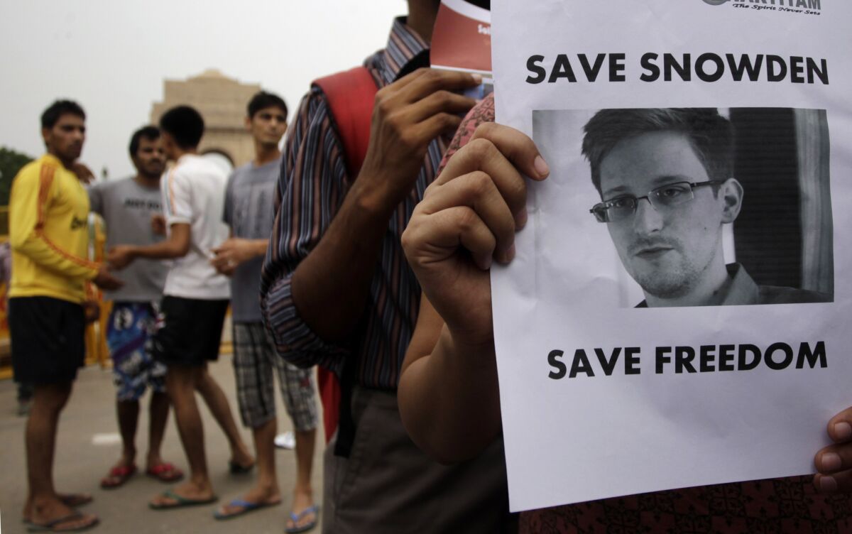 Demonstrators show support for NSA leaker Edward Snowden in New Delhi on Sunday. India denied asylum to Snowden, but he has received offers from Venezuela, Nicaragua and Bolivia.