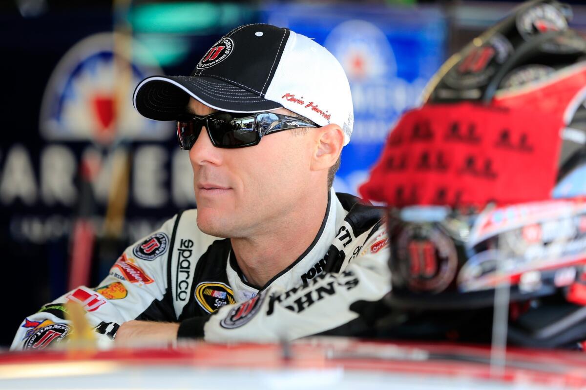 NASCAR driver Kevin Harvick hangs out in the garage area during practice for the NASCAR Sprint Cup Series 5-Hour Energy 400 at Kansas Speedway on Friday.