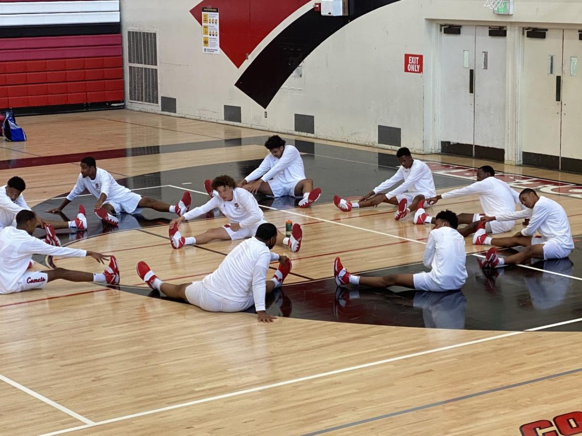 Westchester basketball players stretch on the court before their first game of the season Friday.