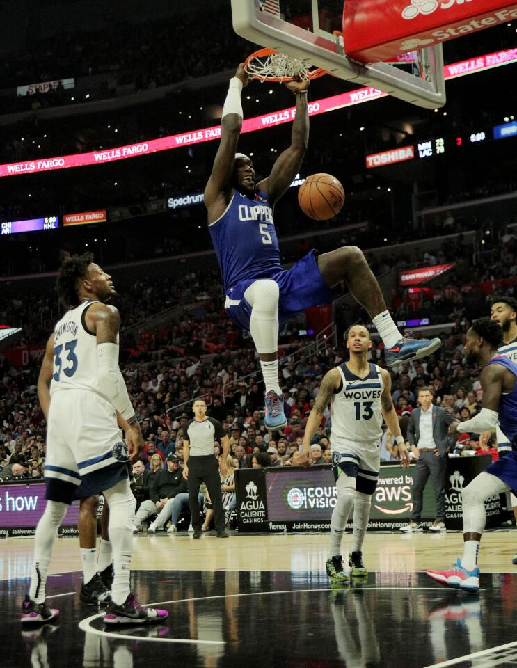 Montrezl Harrell (5) scores easily on a dunk against the Timberwolves during the second half of a game Feb. 1 at Staples Center.