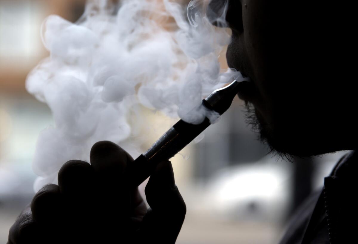 A man demonstrates an e-cigarette at a "vape" store in Chicago.