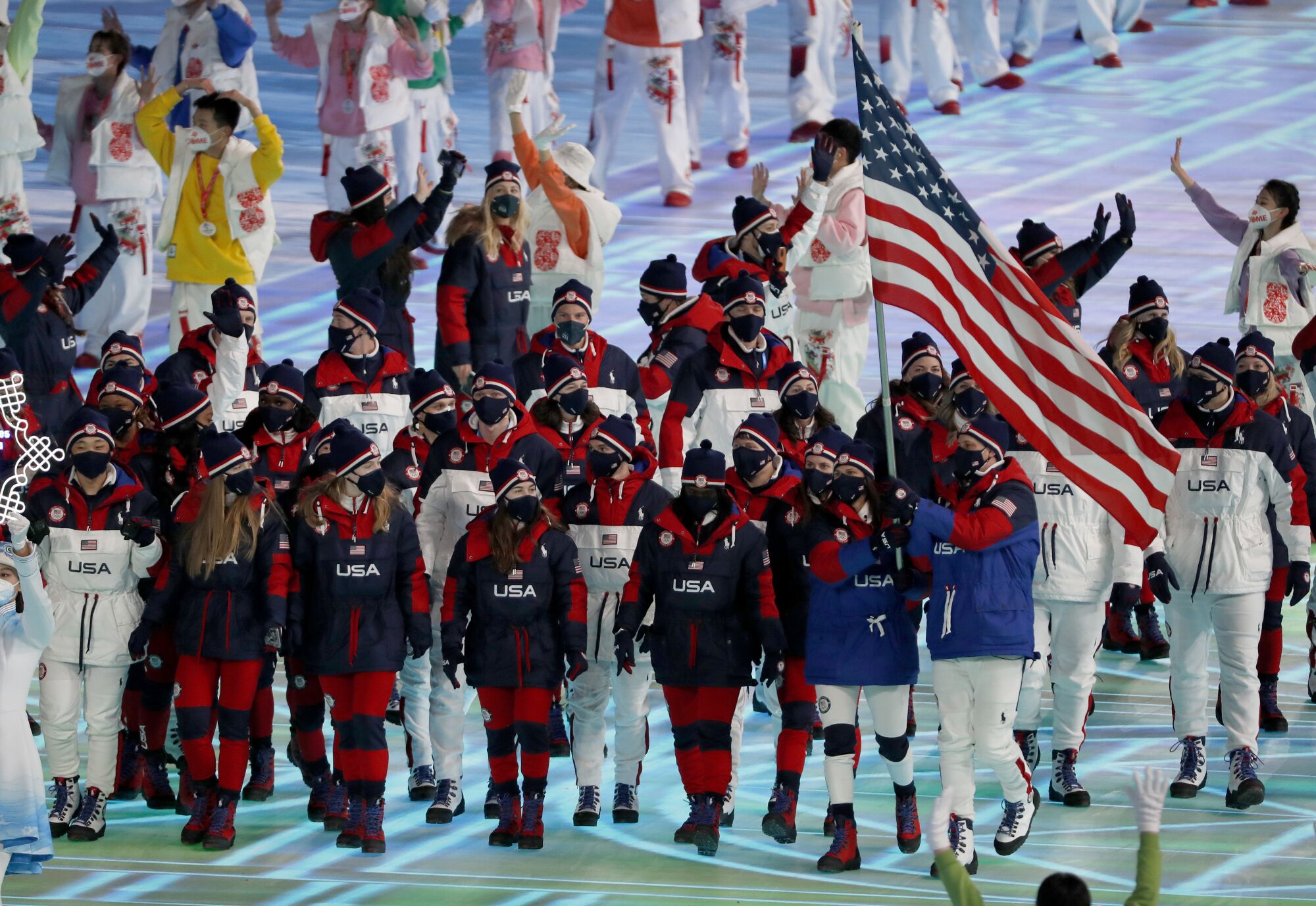 Speed skater Brittany Bowe and  curler John Shuster carry the flag for the U.S. Olympic team.