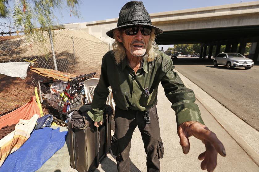 WOODLAND HILLS, CA - SEPTEMBER 12, 2018 Rex Schellenberg, a homeless man who is suing the city of Los Angeles at his homesite on Topanga Canyon Blvd and the 101 Freeway in Woodland Hills on September 12, 2018. Schelleberg says his belongings have been illegally taken to the Calabasas landfill. (Al Seib / Los Angeles Times)