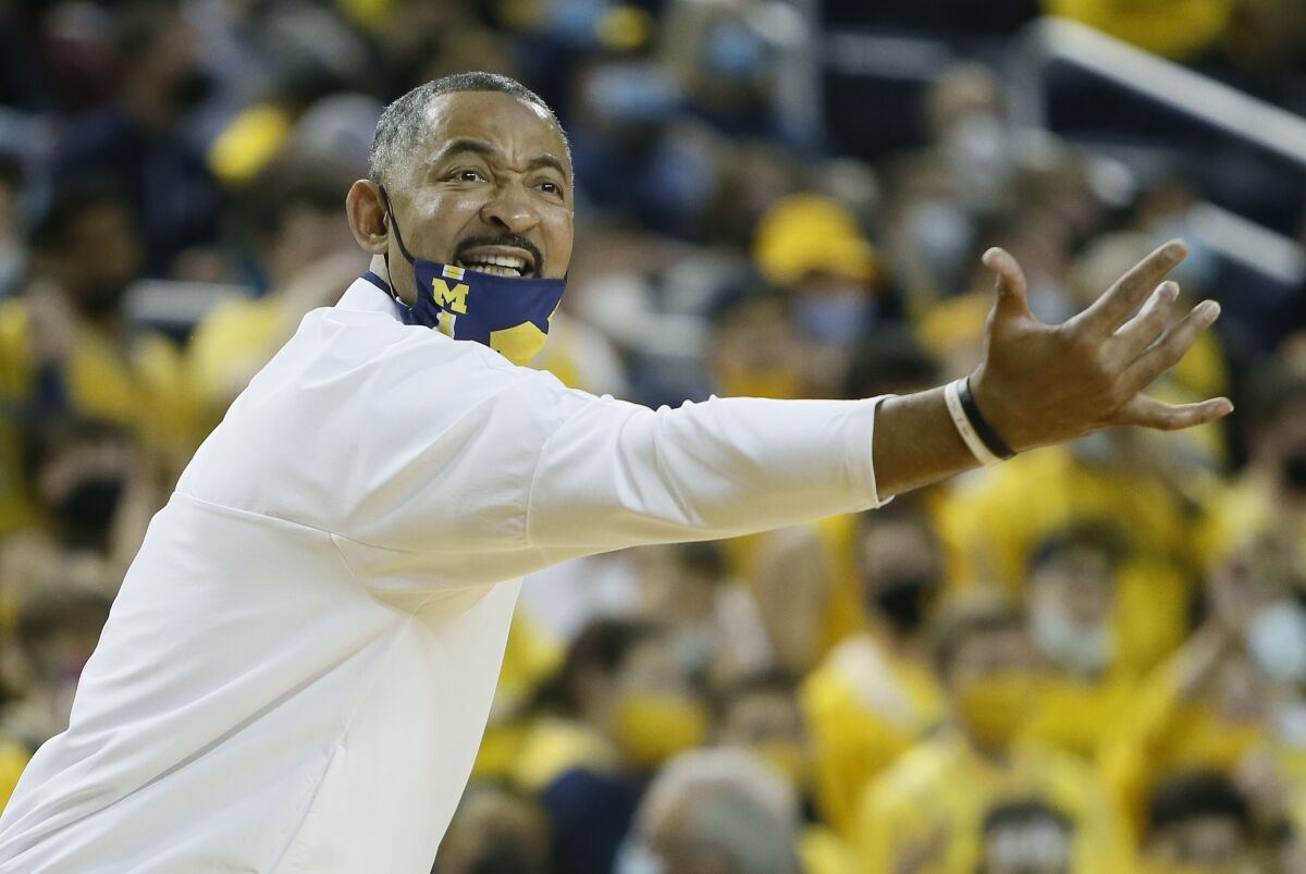Michigan coach Juwan Howard directs the team during the first half of an NCAA college basketball game.
